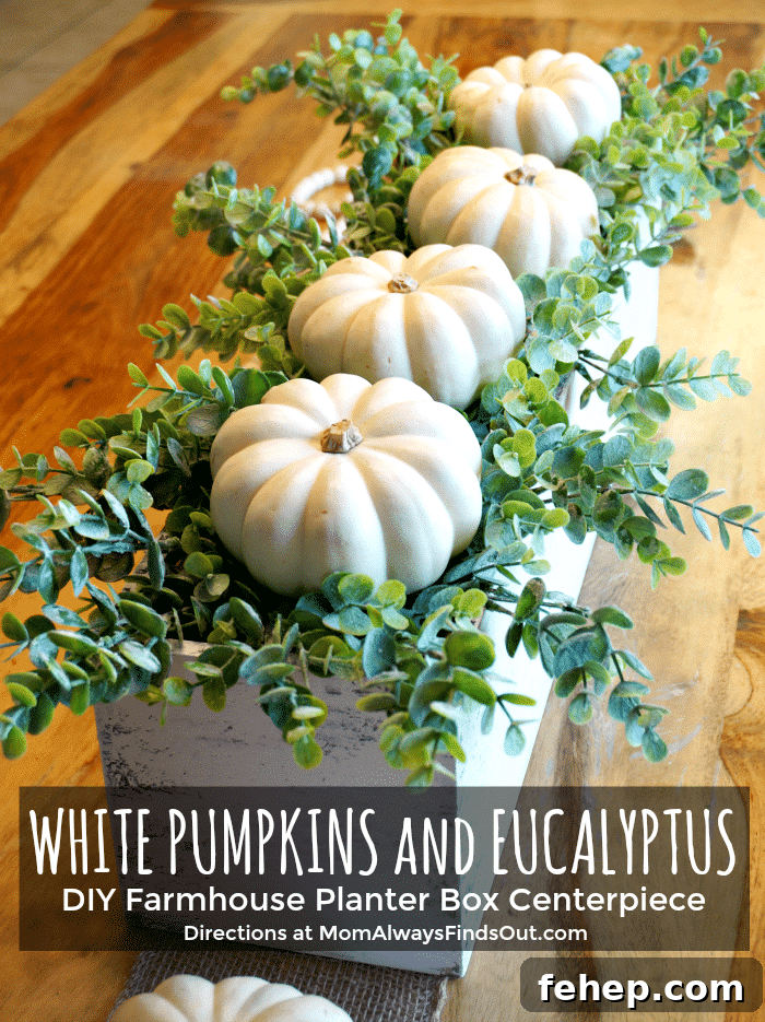 Wooden box centerpiece with pumpkins and eucalyptus