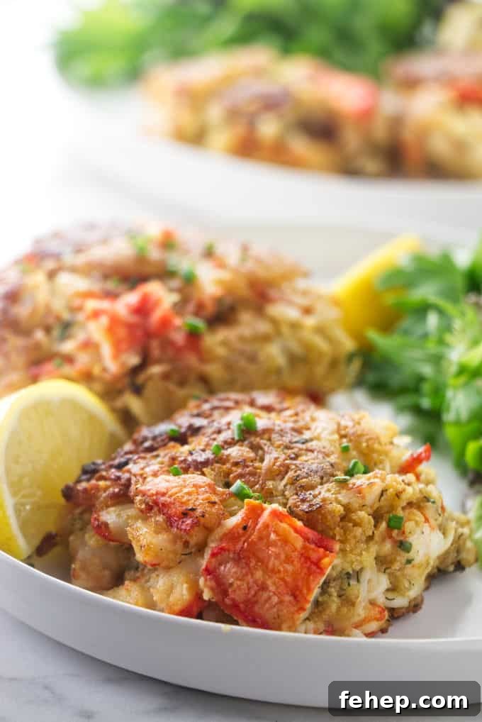 Alaskan King Crab Cakes Recipe: Crispy Pan-Seared Delight 2 King crab cakes on a plate with lemon slices and salad greens.