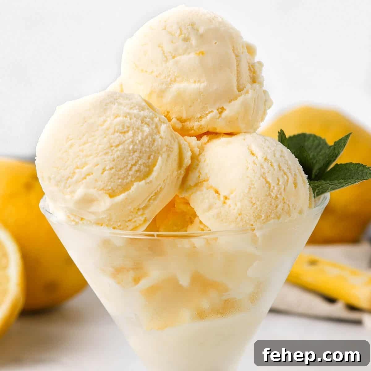 Three scoops of ice cream in a glass dish, garnished with mint.