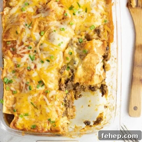 Overhead view of the casserole with a wooden spoon next to it.