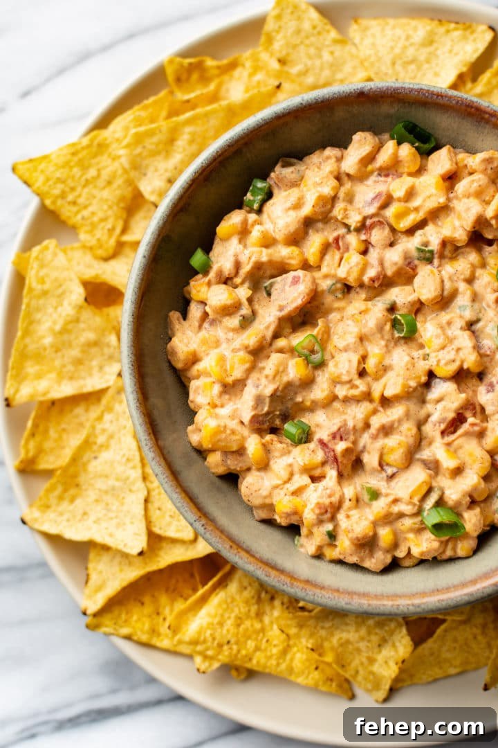Cream Cheese Corn Dip Recipe for Parties and Game Day 2 Rotel cream cheese corn dip in a bowl surrounded by tortilla chips