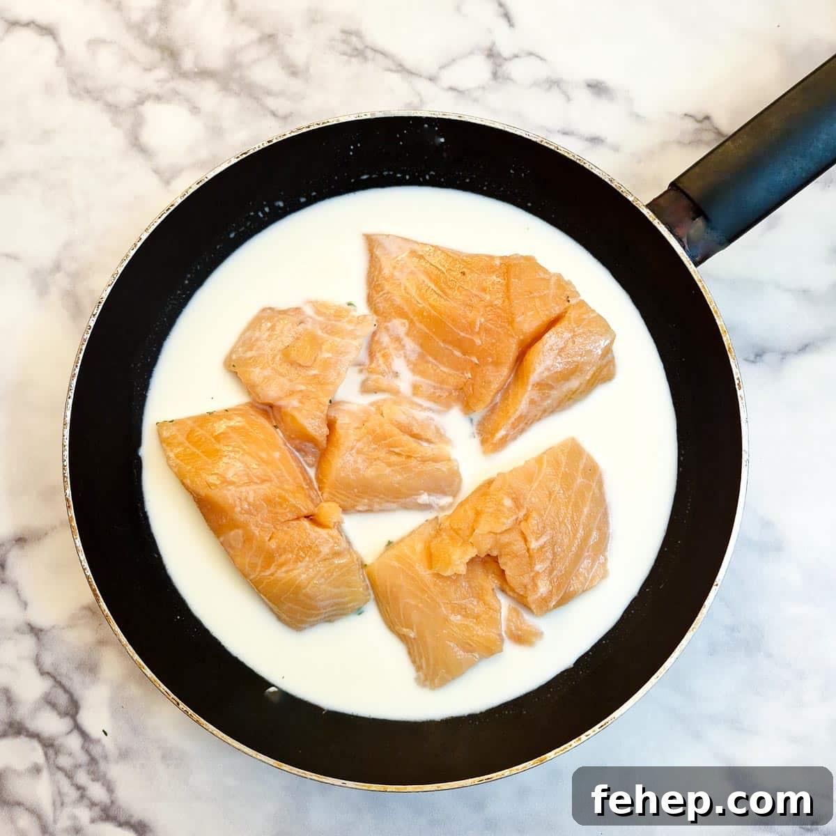Crispy Salmon Fish Cakes with Lemon-Dill Sauce 6 Salmon filets in a frying pan of milk.