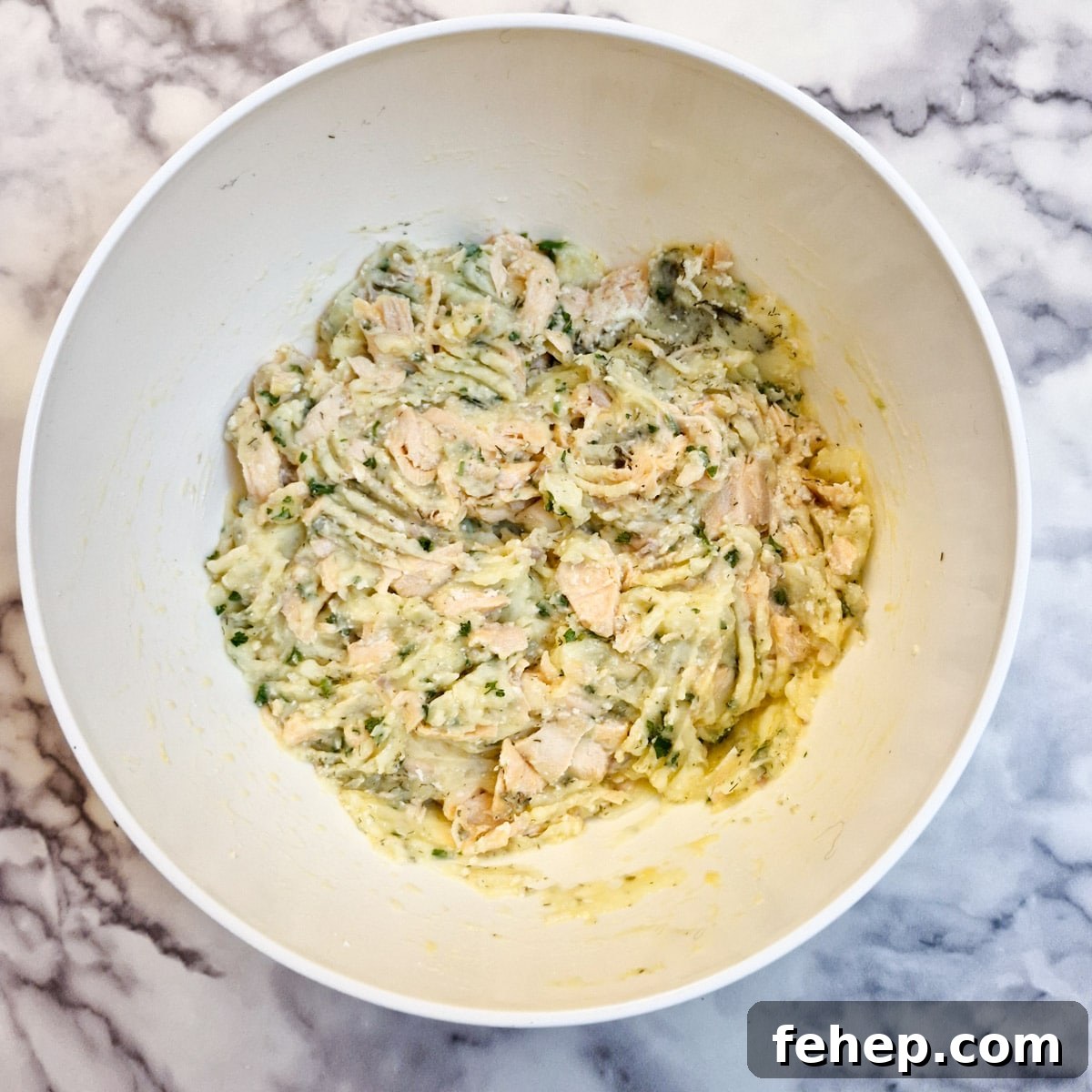 Crispy Salmon Fish Cakes with Lemon-Dill Sauce 9 Salmon fishcake ingredients combined in a mixing bowl.