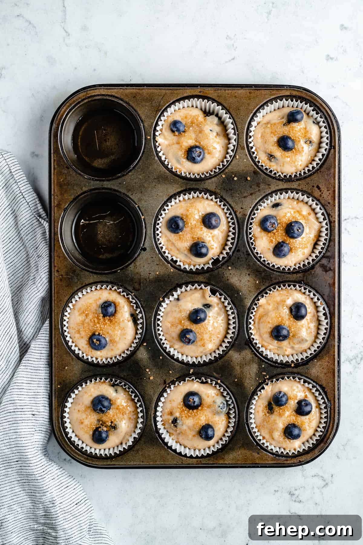 Vegan Blueberry Muffins Recipe for Moist, Fluffy Results 9 Muffin batter in a muffin pan.