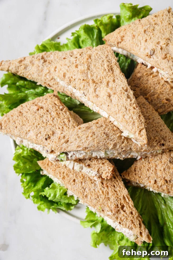 Creamy Chicken Mayo Sandwich Recipe for Balanced Flavor 2 Top view of a platter of Chicken Mayo Sandwiches on a bed of lettuce.