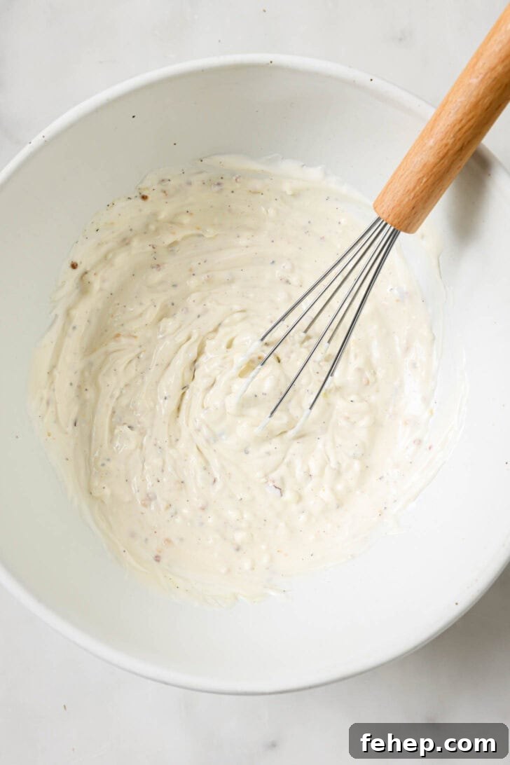 Creamy Chicken Mayo Sandwich Recipe for Balanced Flavor 10 Mayo mixture whisked in a bowl for Chicken Sandwiches.