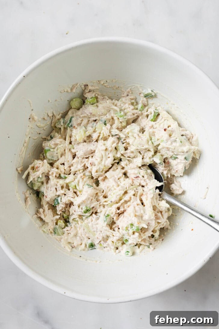 Creamy Chicken Mayo Sandwich Recipe for Balanced Flavor 13 Shredded chicken added and mixed into mayo mixture ready to be made into sandwiches.