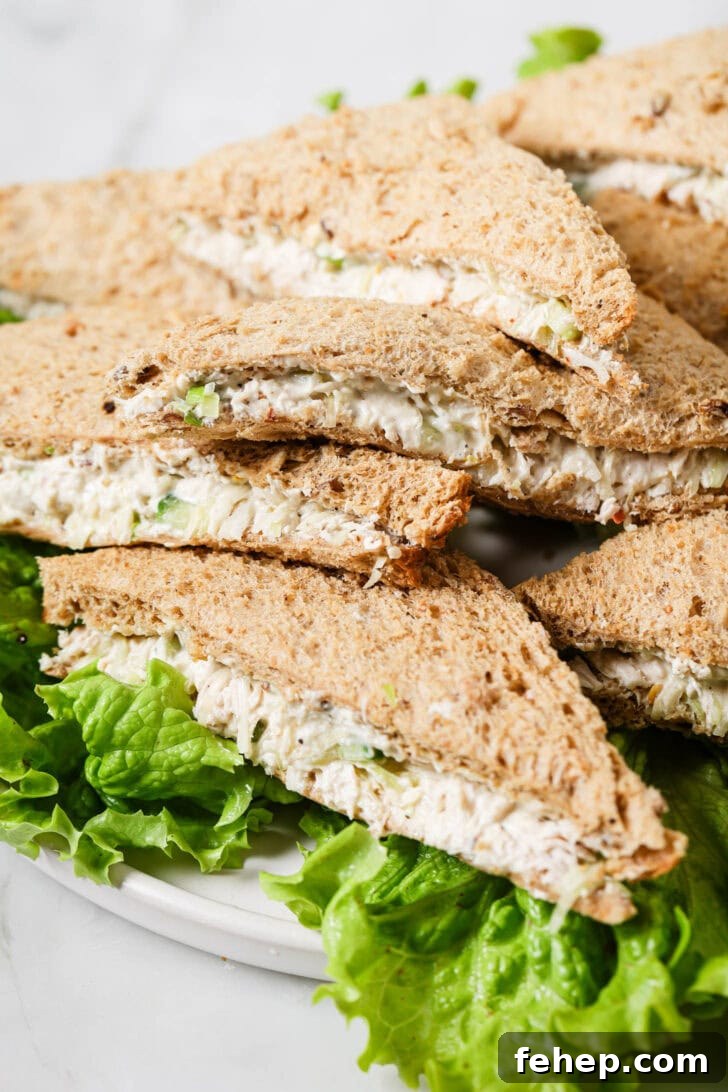 Creamy Chicken Mayo Sandwich Recipe for Balanced Flavor 6 Platter of Chicken Sandwiches on a bed of lettuce.