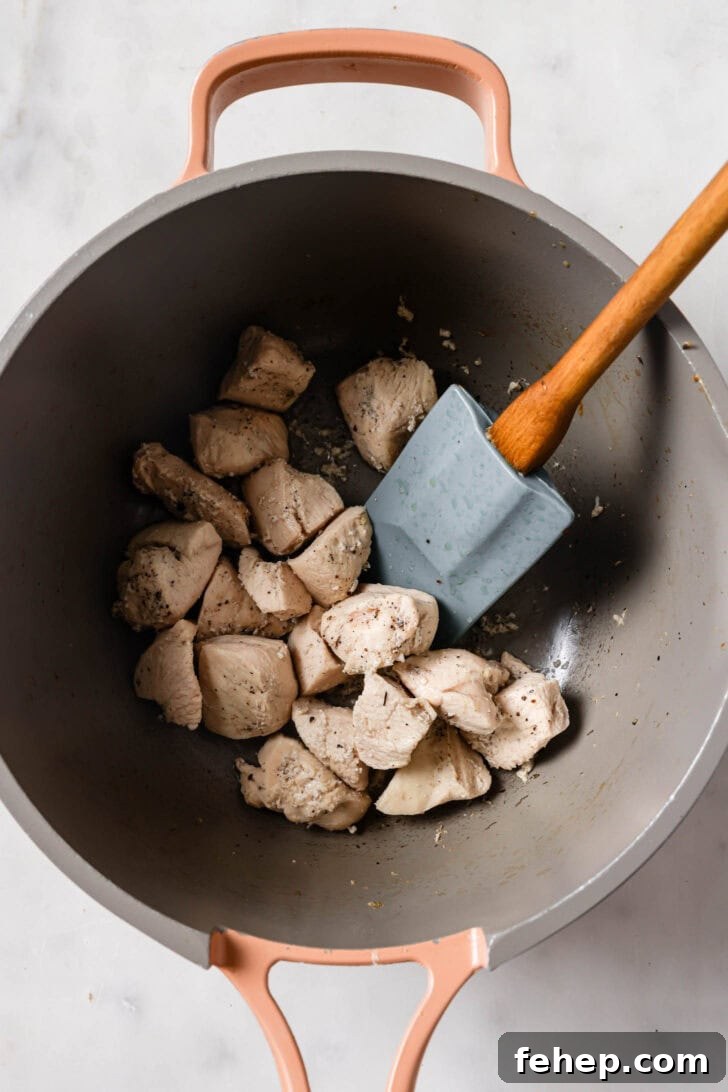 Creamy Chicken Mayo Sandwich Recipe for Balanced Flavor 8 Cooked chicken in a pot for Chicken Sandwiches.