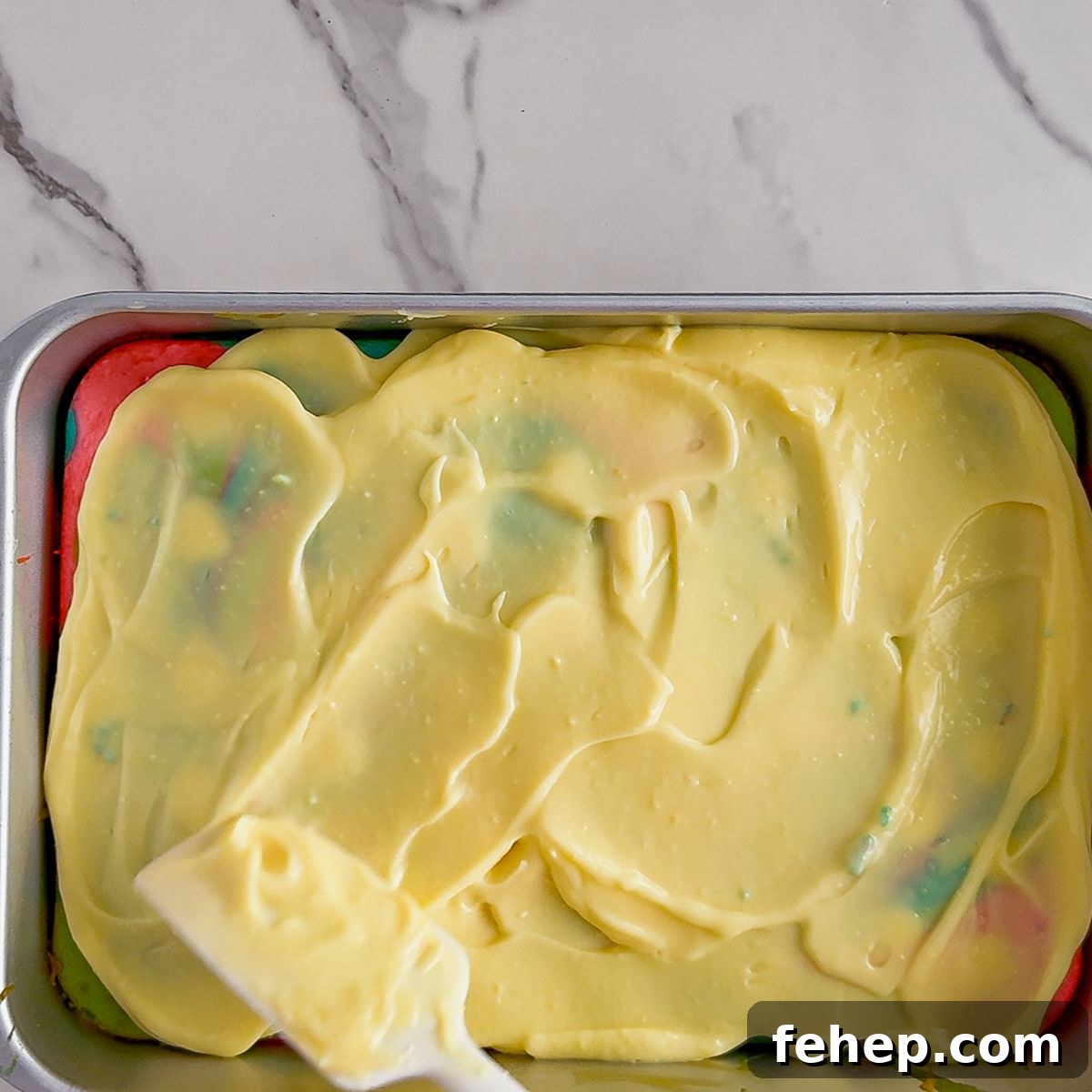 Spreading pudding on poke cake.