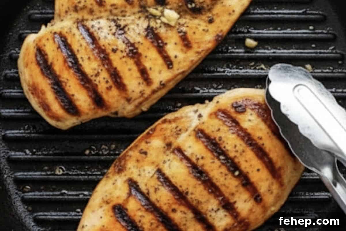 Season chicken with olive oil, lemon juice, garlic, oregano, salt, and pepper. Grill in a skillet or pan until golden and cooked.