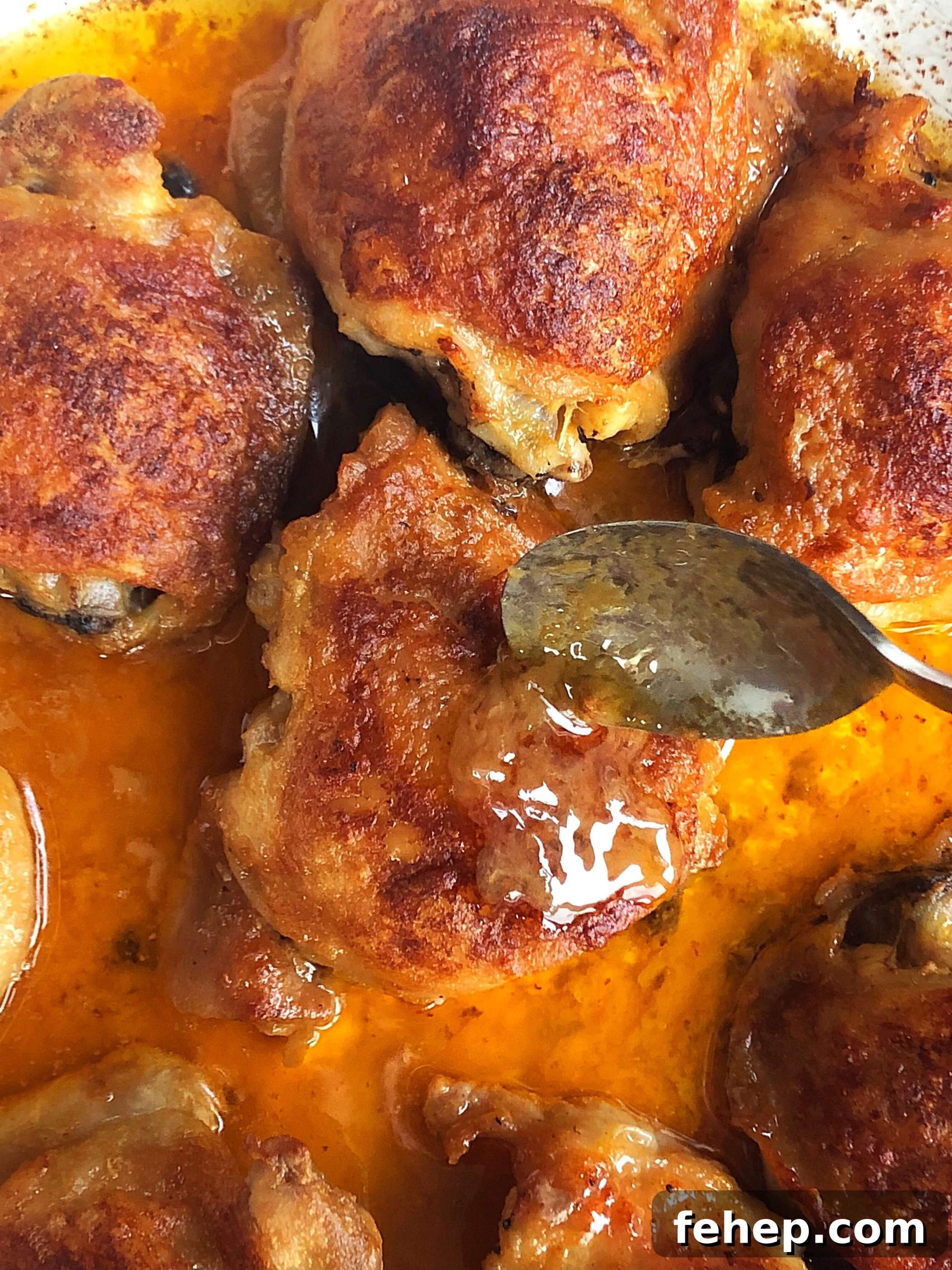 Basting the baked chicken thighs