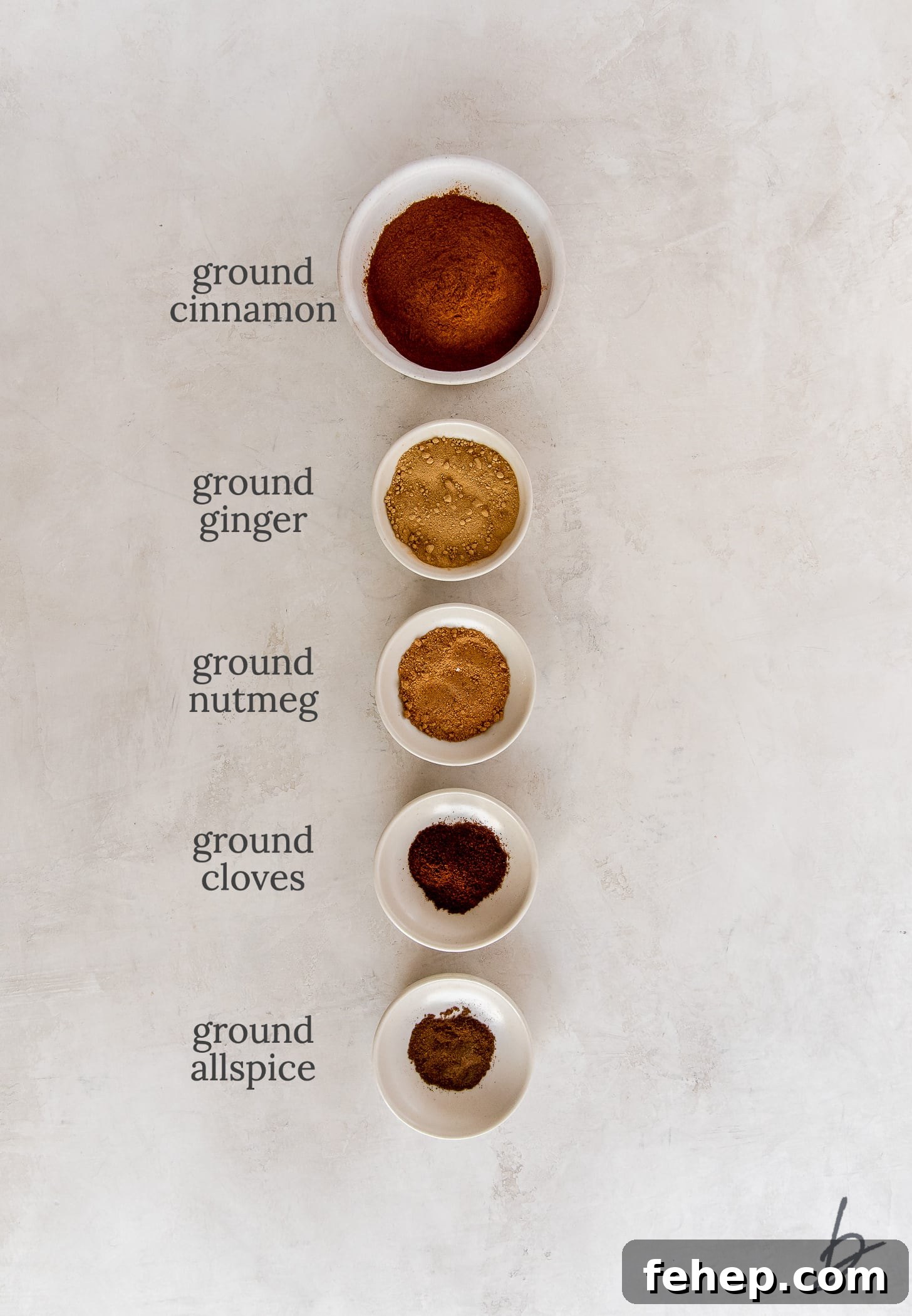individual pumpkin pie spices in bowls labeled with text