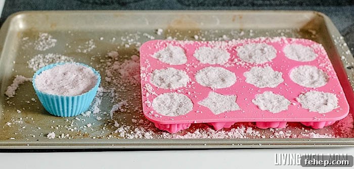 putting DIY bath bombs mixture into molds