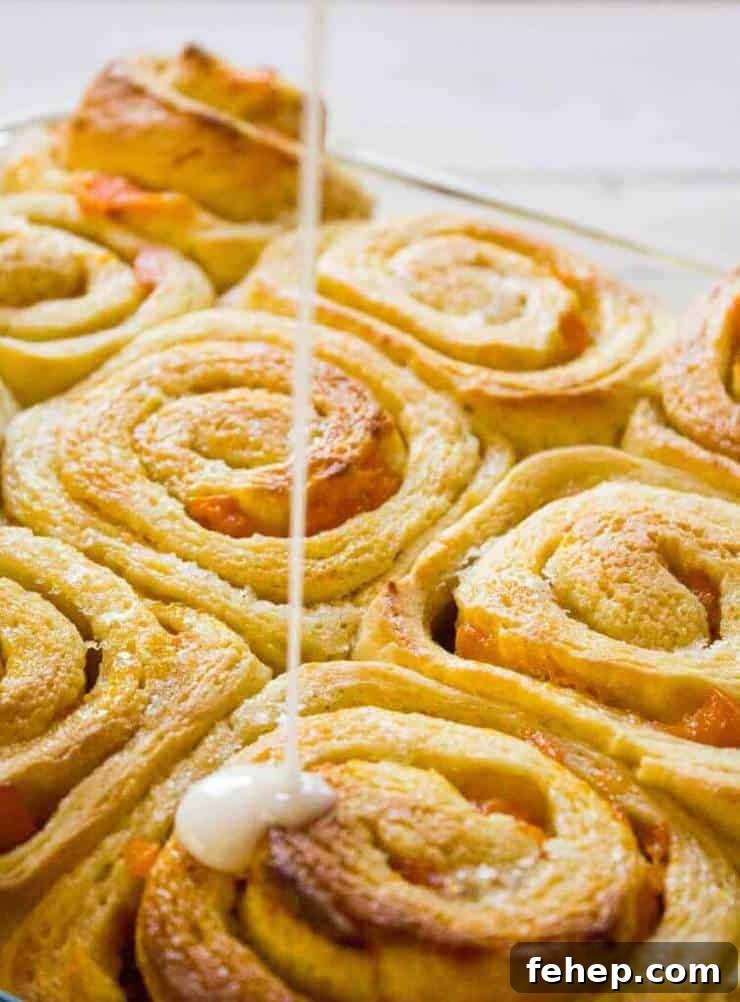 Apricot Sweet Rolls Recipe: Soft, Sticky Fruit-Glazed Buns 4 A glaze being drizzled over a pan of sweet rolls.