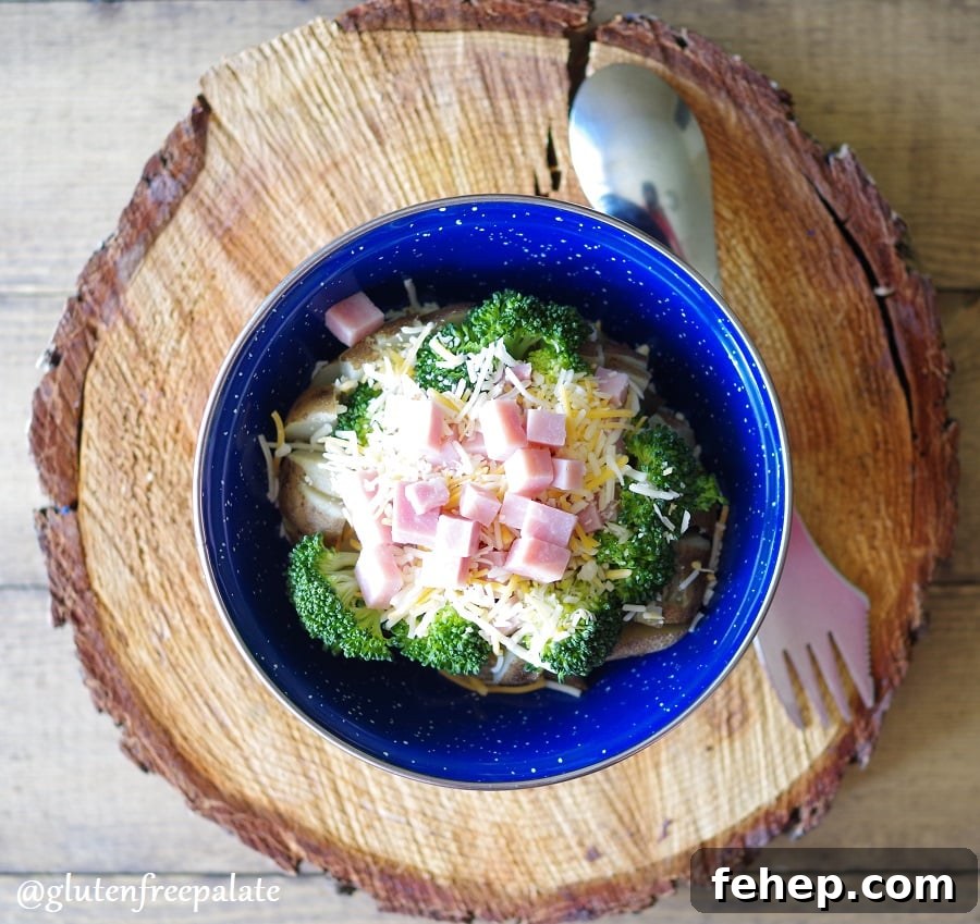 Gluten-Free Camping Meal Ideas for Delicious Outdoor Cooking 12 a baked potato covered with broccoli, cheese, and diced ham in a blue bowl