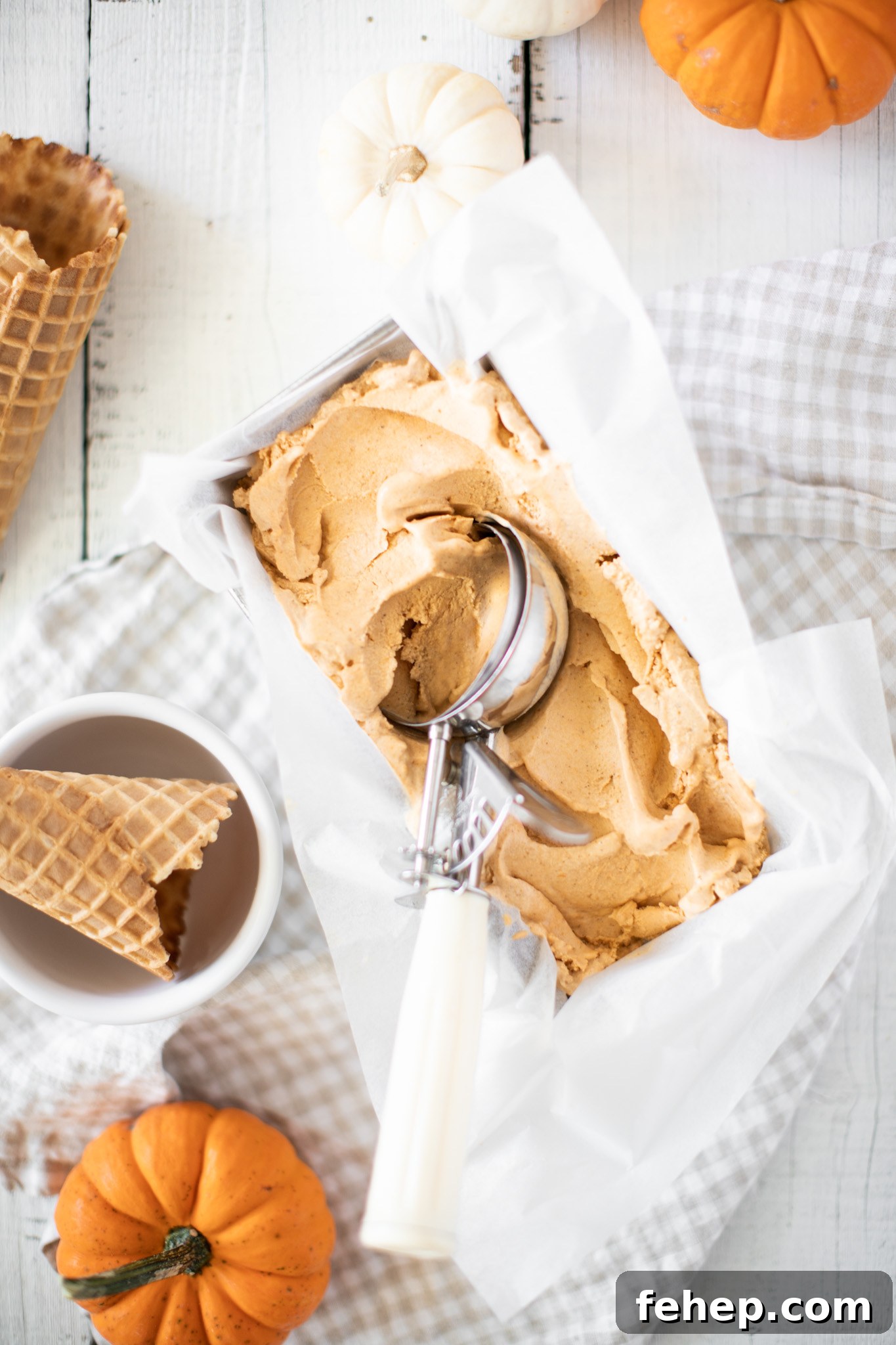 Pumpkin Pie Ice Cream with a scoop and waffle cones