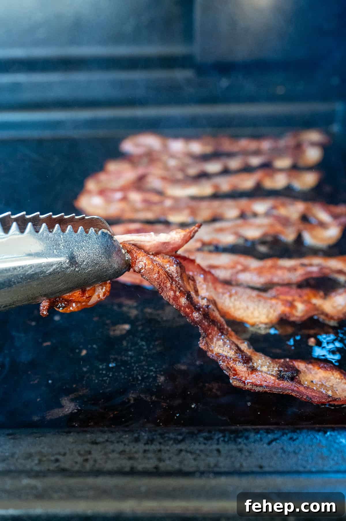 Griddle Bacon and Eggs: Perfectly Cooked Breakfast in Minutes 6 Flipping bacon on griddle.