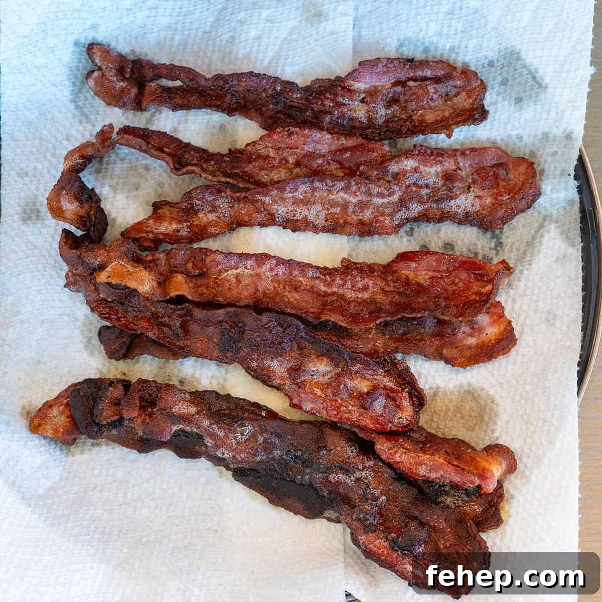 Griddle Bacon and Eggs: Perfectly Cooked Breakfast in Minutes 8 cracked eggs on griddle.