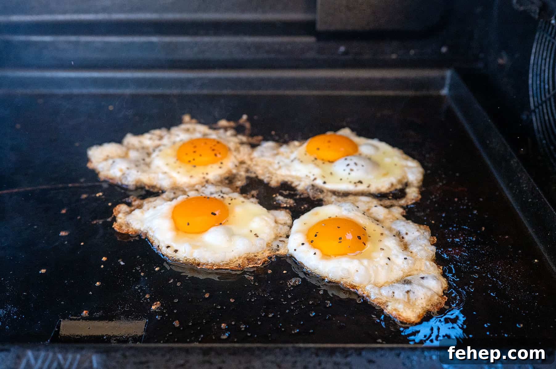 Griddle Bacon and Eggs: Perfectly Cooked Breakfast in Minutes 9 cracked eggs on griddle.