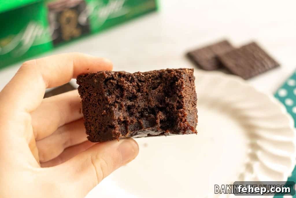 hand holding one of the after eight brownies with a bite missing