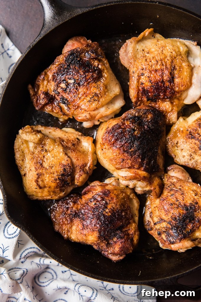 Sheet Pan Chicken and Vegetable Stir-Fry Recipe for Quick Dinners 3 Crispy chicken thighs on a cast iron skillet