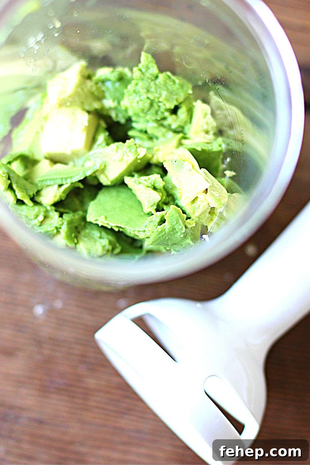 Container with cut avocado in it.