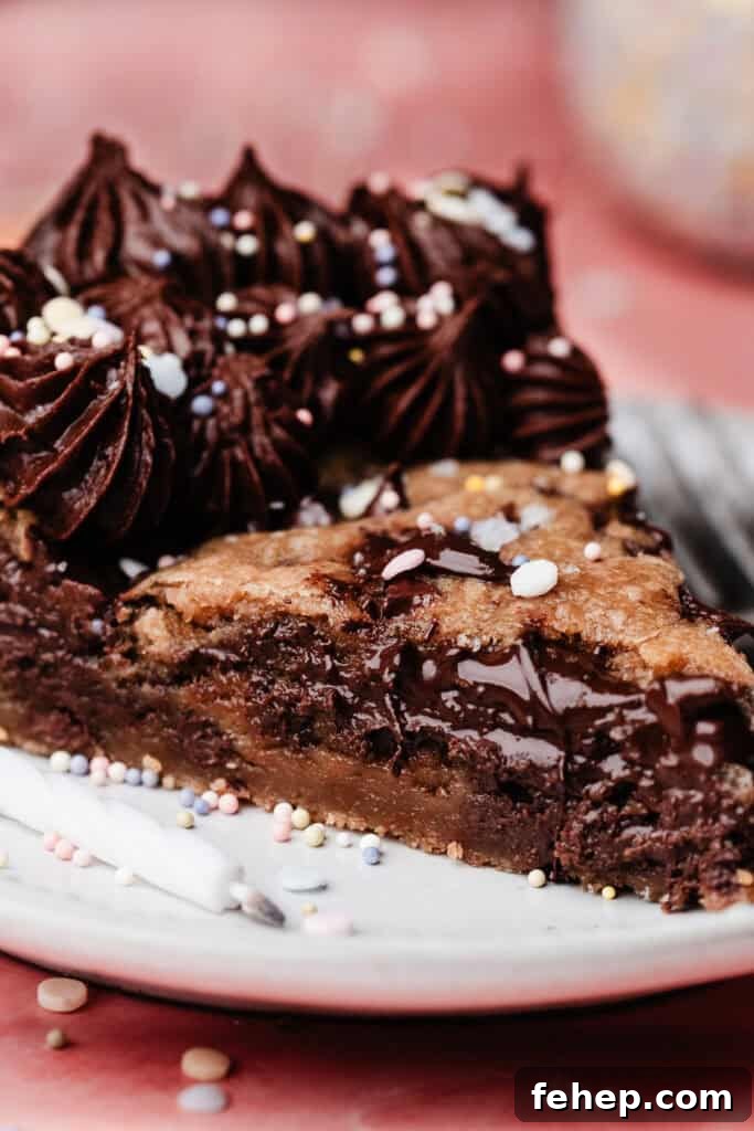 A close-up on a slice of the gooey chocolate chip cookie cake.
