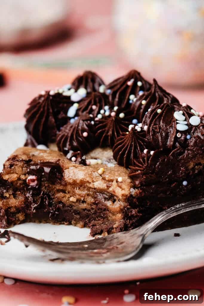 A close-up of a slice of the cookie cake, with a few bites missing to show the gooey texture inside.