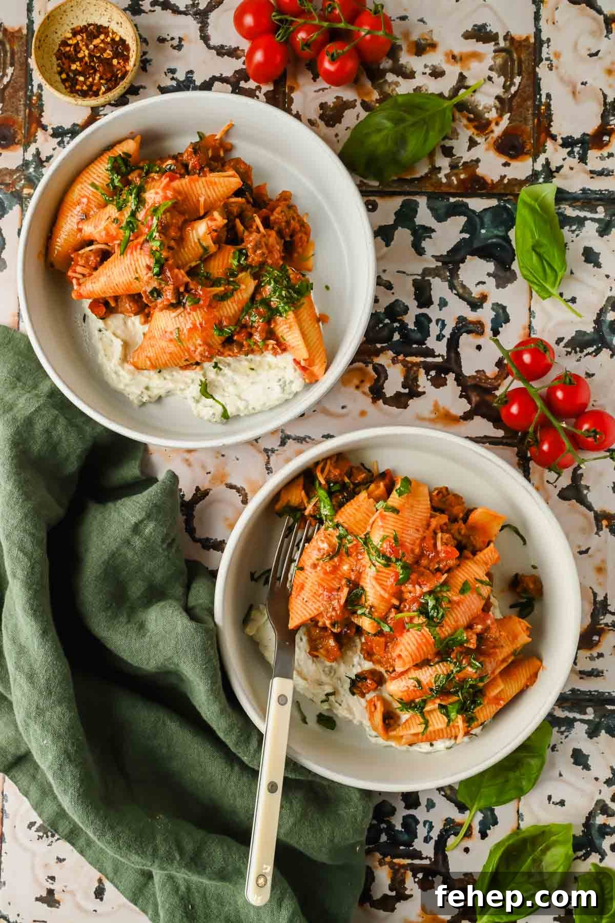 Unstuffed Shells Recipe: Cheesy Baked Pasta Skillet 8 two servings of unstuffed pasta shells in red meat sauce on creamy cheesy mixture in white bowls.