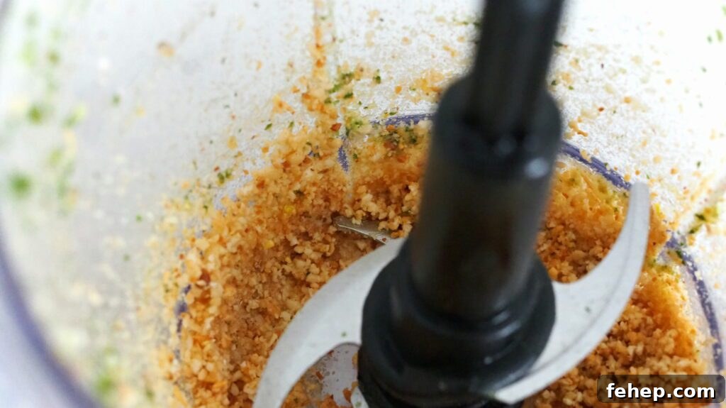 Garlic and pine nuts are blitzed to fine particles.