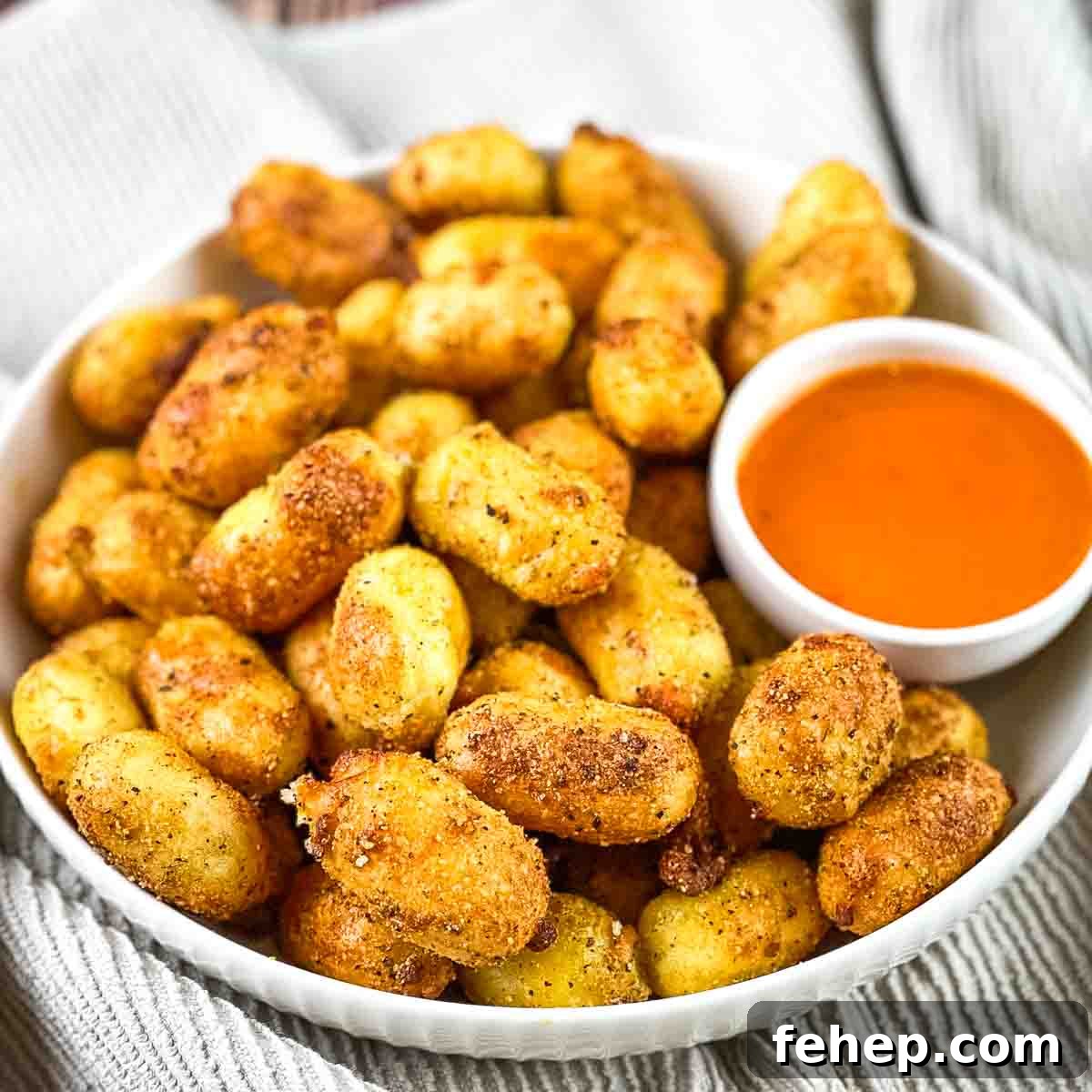 Crispy Air-Fried Gnocchi with Garlic Parmesan Crunch 9 A bowl piled high with crispy gnocchi and dipping sauce.