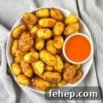 Crispy Air-Fried Gnocchi with Garlic Parmesan Crunch 10 Crispy air fried gnocchi stacked in a white bowl with buffalo dipping sauce.