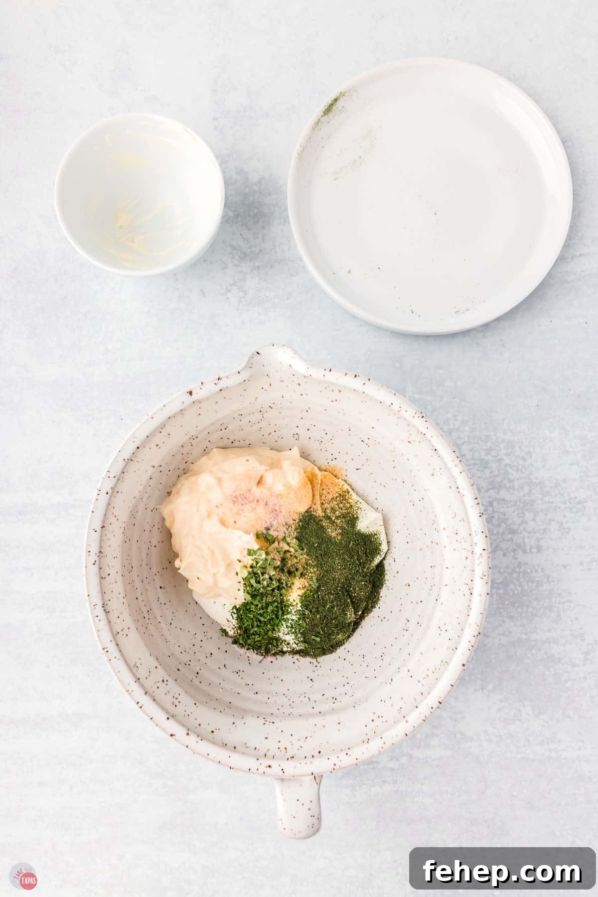 bowl of unmixed sour cream and spices 