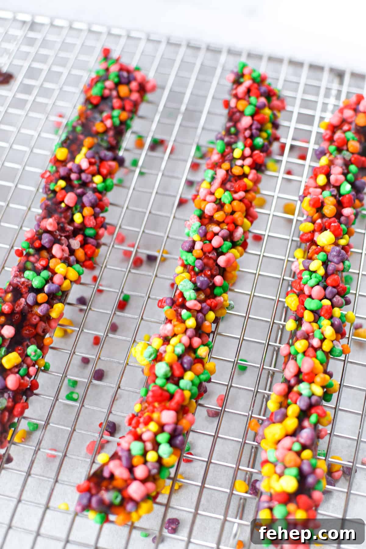 How to Make Cannabis-Infused Candy Ropes at Home 2 Three cannabis nerds ropes resting on a metal baking rack