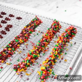How to Make Cannabis-Infused Candy Ropes at Home 9 Three cannabis nerds ropes resting on a metal baking rack