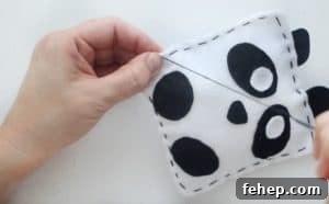 Panda Plush Sewing Pattern for Kids with Video Tutorial 12 stitching the opening closed with black thread