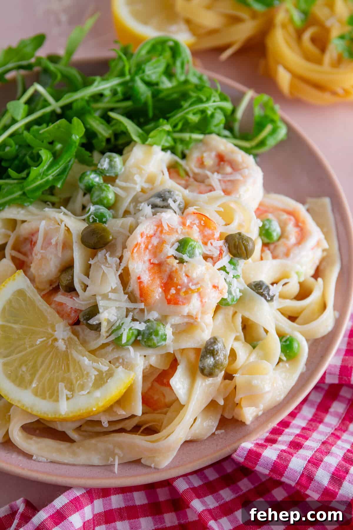 Creamy Garlic Prawn Pasta with Parmesan and Lemon 2 A plate of creamy prawn pasta with lemon and capers.