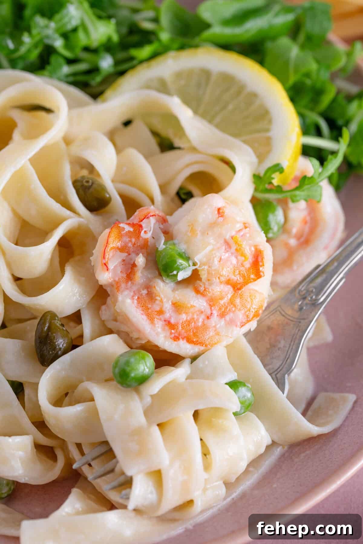 Creamy Garlic Prawn Pasta with Parmesan and Lemon 3 A plate of creamy prawn pasta with lemon and capers.