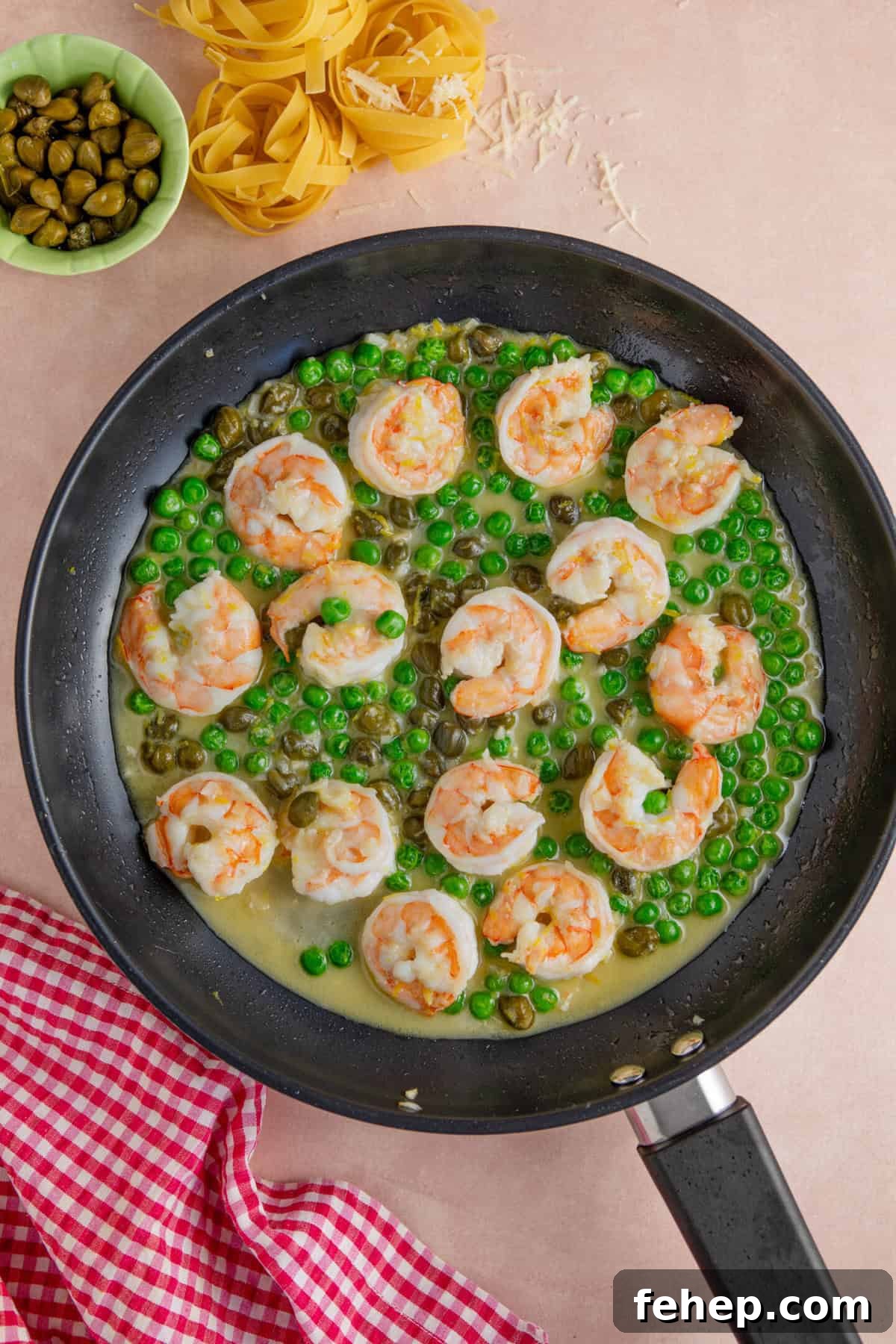 Creamy Garlic Prawn Pasta with Parmesan and Lemon 6 Add the white wine and peas to the pan.