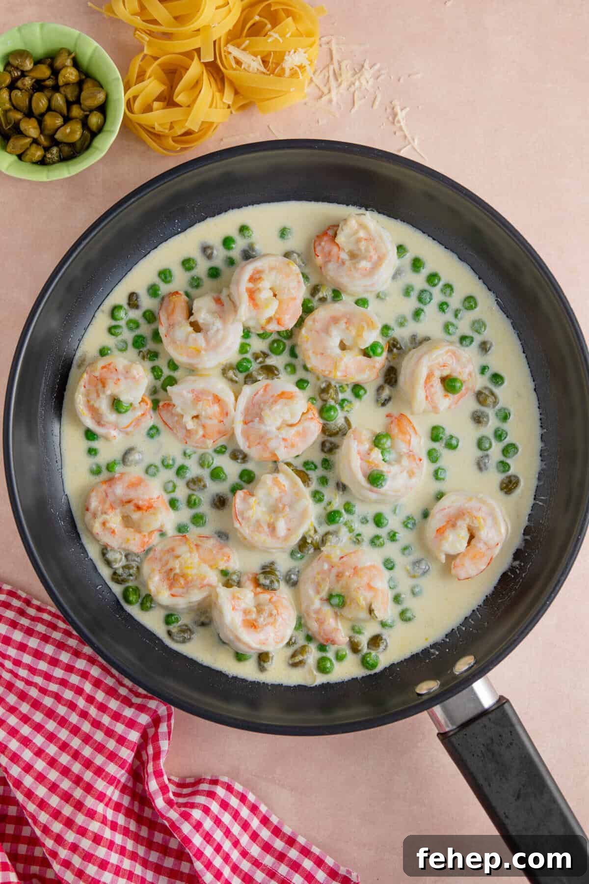 Creamy Garlic Prawn Pasta with Parmesan and Lemon 7 Add the double cream to the pan and reduce the sauce.