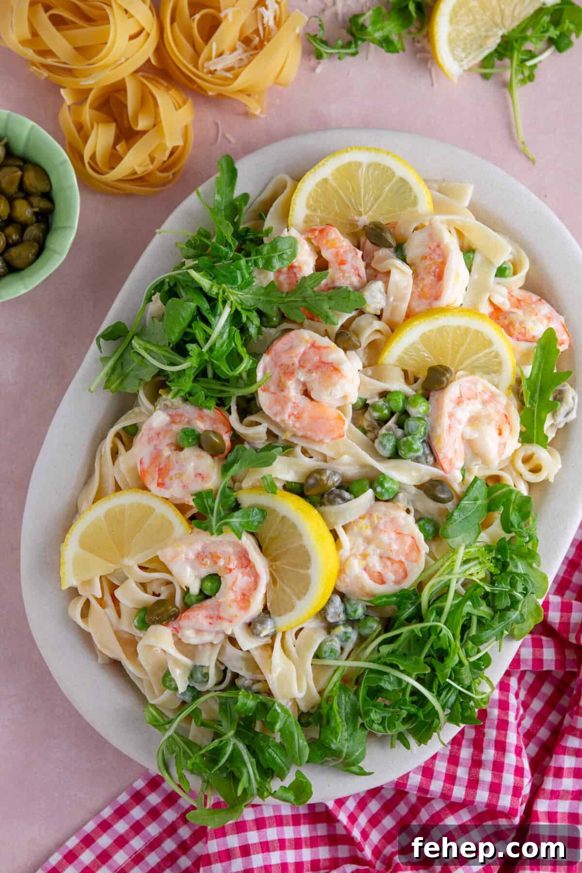 Creamy Garlic Prawn Pasta with Parmesan and Lemon 9 A plate of creamy prawn pasta with rocket, lemon and capers.