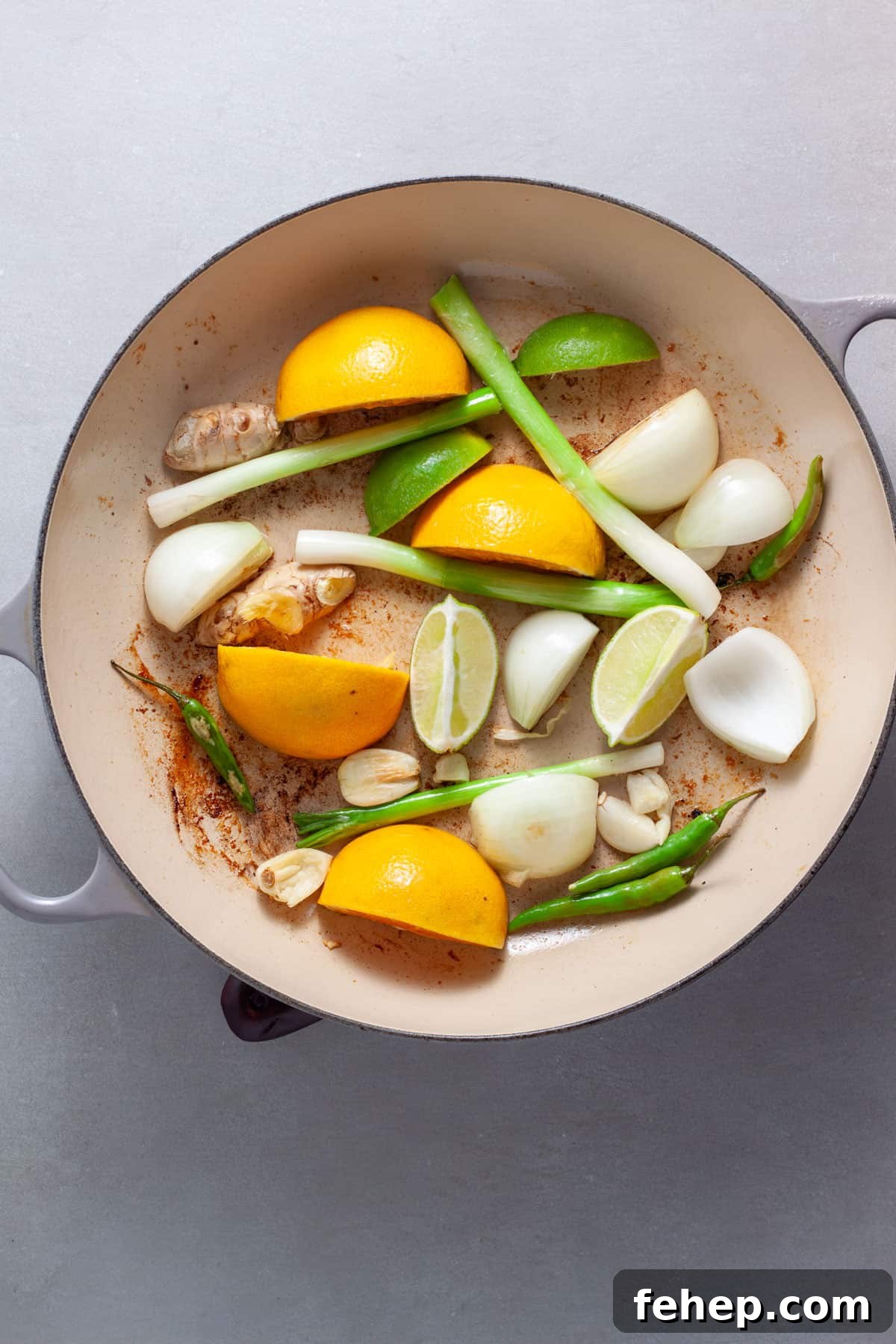 Ginger Citrus Soy Chicken with Spicy Sesame Glaze 6 Scallions, citrus, ginger, onion and garlic in a skillet cooking.