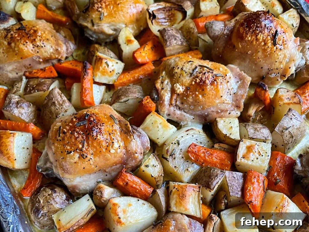 Spanish-Style Pork Chops with Garlic Tomato Rice 9 One pan roasted chicken and vegetables in a foil and parchment paper lined baking sheet.
