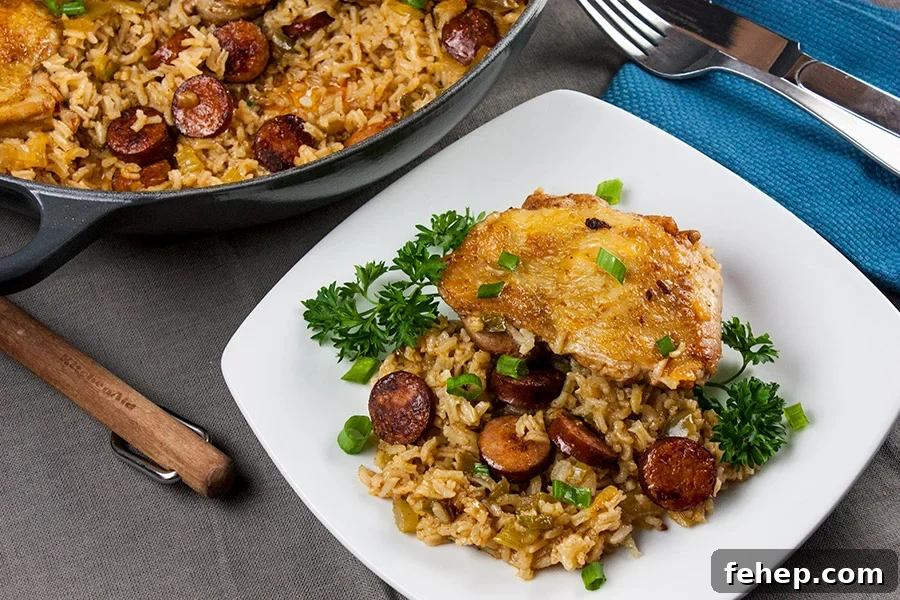 Spanish-Style Pork Chops with Garlic Tomato Rice 10 One pan chicken and dirty rice served on a white plate.