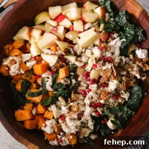 an overhead shot of a fall harvest salad in a wooden bowl