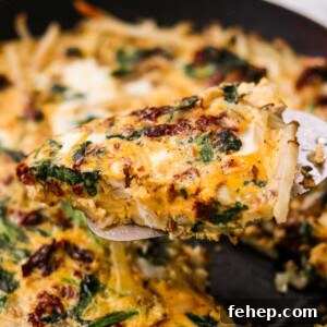 Dairy free veggie frittata slice lifted with a spatula.