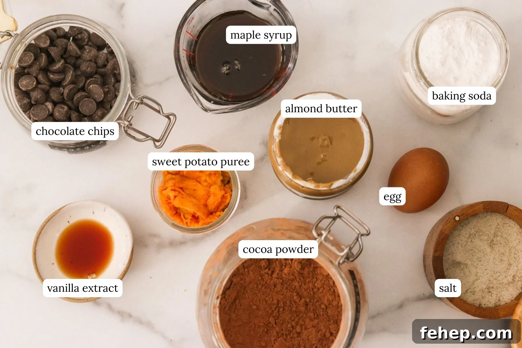 Sweet potato brownies recipe ingredients laid out and labeled on a white countertop.