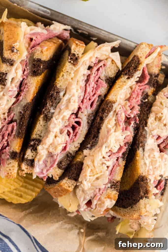 Classic Reuben Sandwich Recipe: Crispy Corned Beef & Melted Swiss 3 looking down on halves of a reuben sandwich in a container