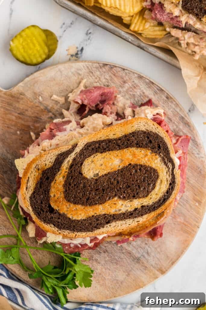 Classic Reuben Sandwich Recipe: Crispy Corned Beef & Melted Swiss 5 looking down onto a whole reuben sandwich on a wooden cutting board